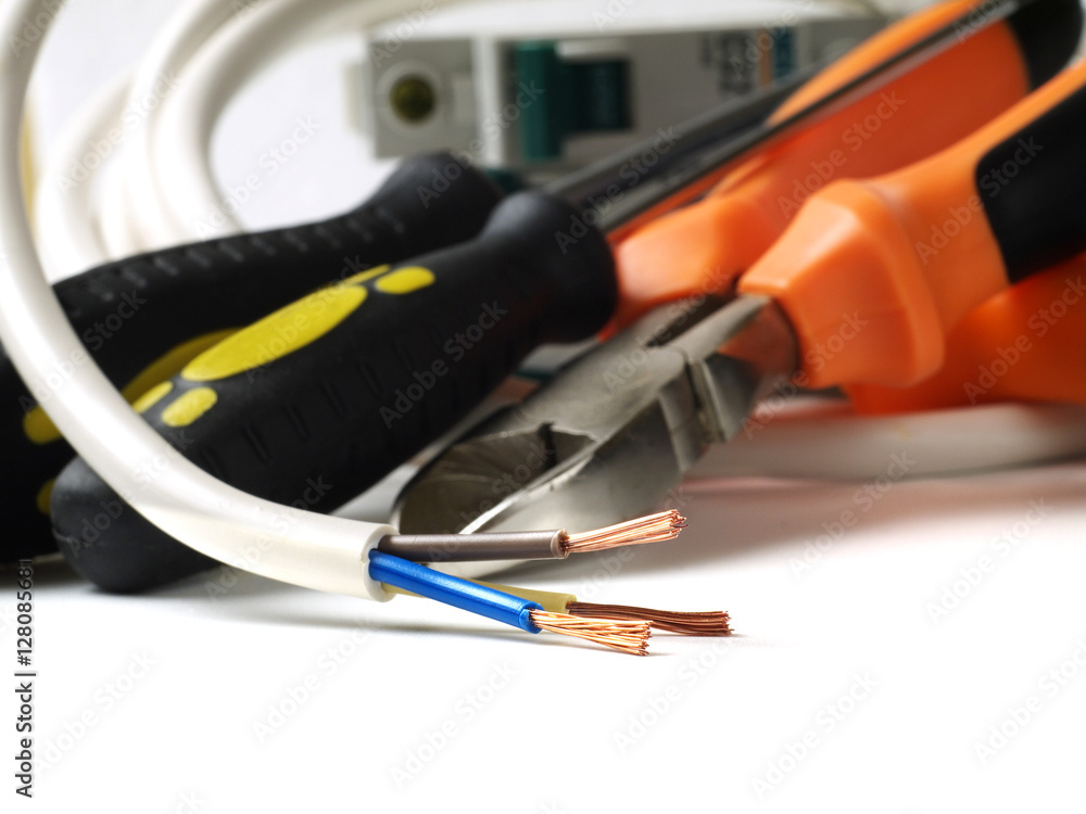 stripped wire in front of electric tools and equipment, shallow depth of field stripped wire in front of electric tools and equipment, shallow depth of field