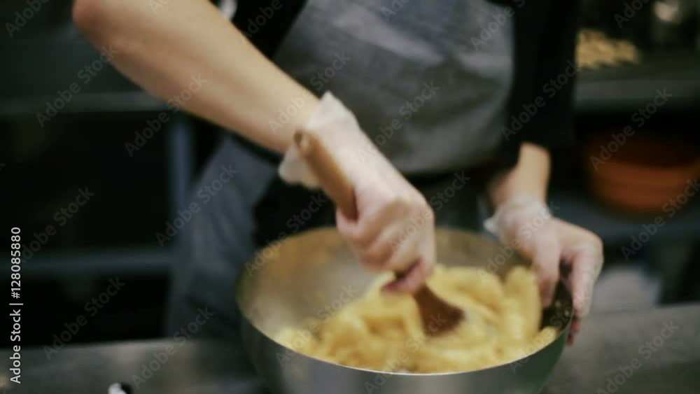 Confectioner stir cookie dough in a bowl. Confectioner stir cookie dough in a bowl.