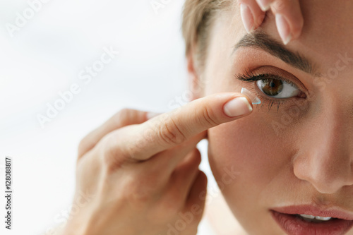Vision Contact Lenses. Closeup With Beautiful Woman Face