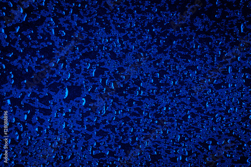 Water drops on blue stone surface