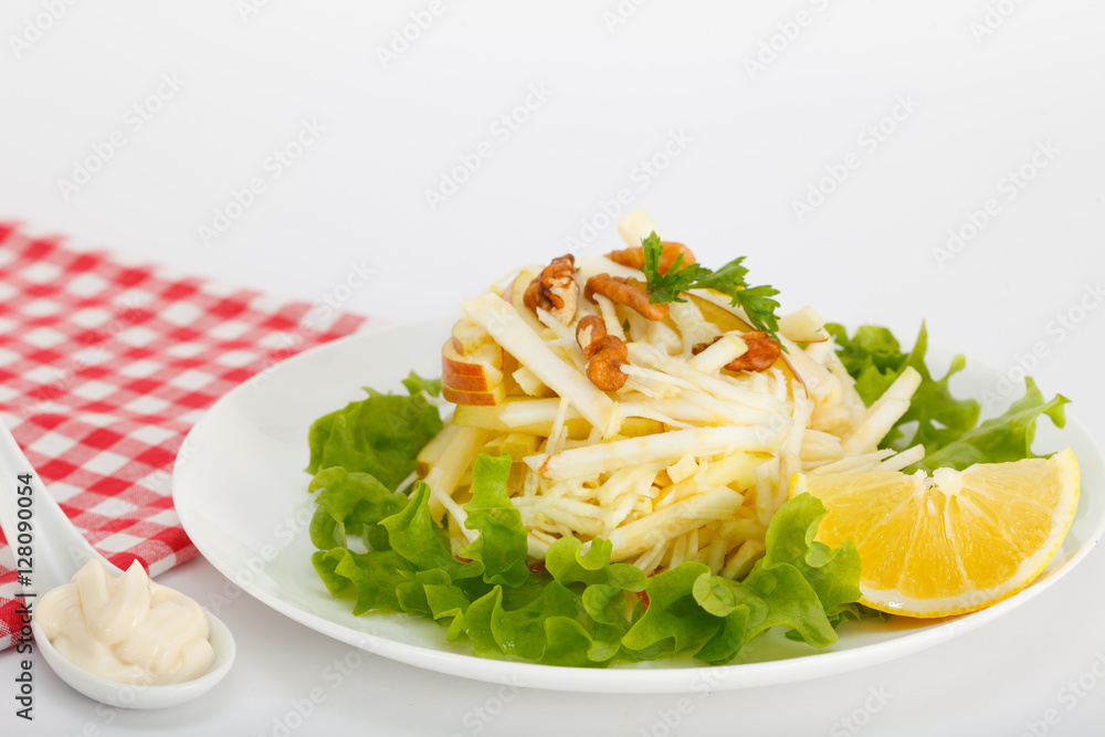 Waldorf Salad with green apples, celery and walnuts on a white plate Waldorf Salad with green apples, celery and walnuts on a white plate