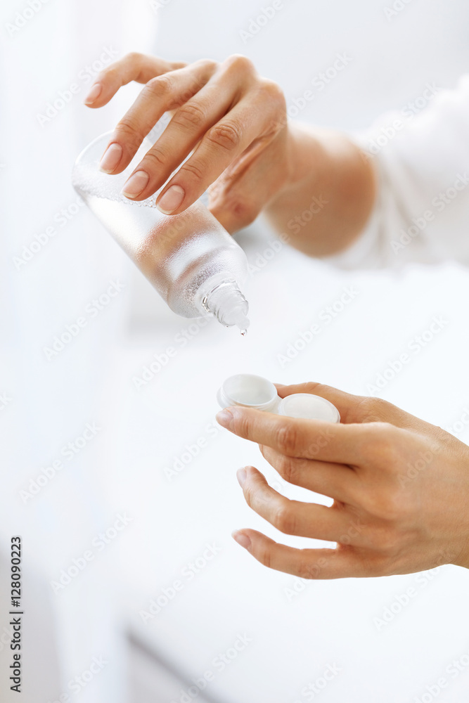 Woman Hands Putting Liquid From Bottle To Lens Box Woman Hands Putting Liquid From Bottle To Lens Box