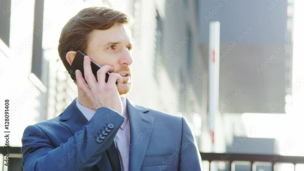 Young Businessman Being Outdoors and Having a Phone Call Young Businessman Being Outdoors and Having a Phone Call