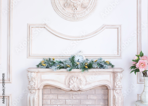 Christmas morning. classic apartments with a white fireplace, decorated tree, bright sofa