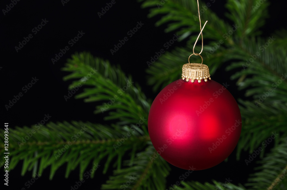 Red glass bauble, a spherical Christmas ornament, usually hung on a  Christmas tree. Christmas ball, a