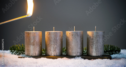 Light four advents candles with matches