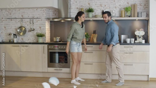 Young Couple Quarrels in the Kitchen. Girl Had Enough and She Breaks the Plate. Man Screams in Frustration and Angrily Gesticulates. Shot on RED Cinema Camera in 4K (UHD).