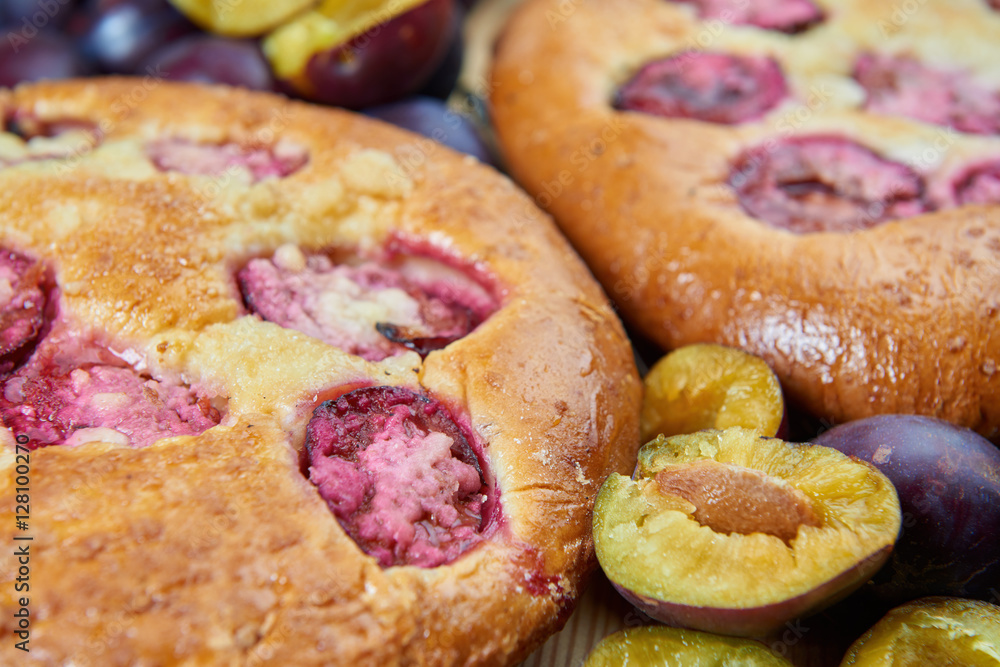 Home made plum buns on a wooden table Home made plum buns on a wooden table