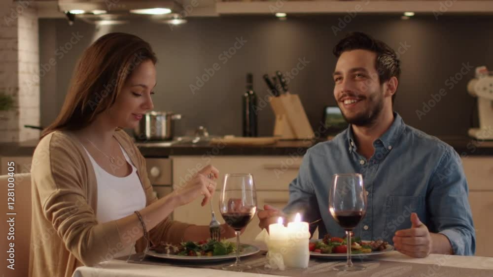 Beautiful Couple Having Candlelight Dinner in the Kitchen Beautiful Couple Having Candlelight Dinner in the Kitchen