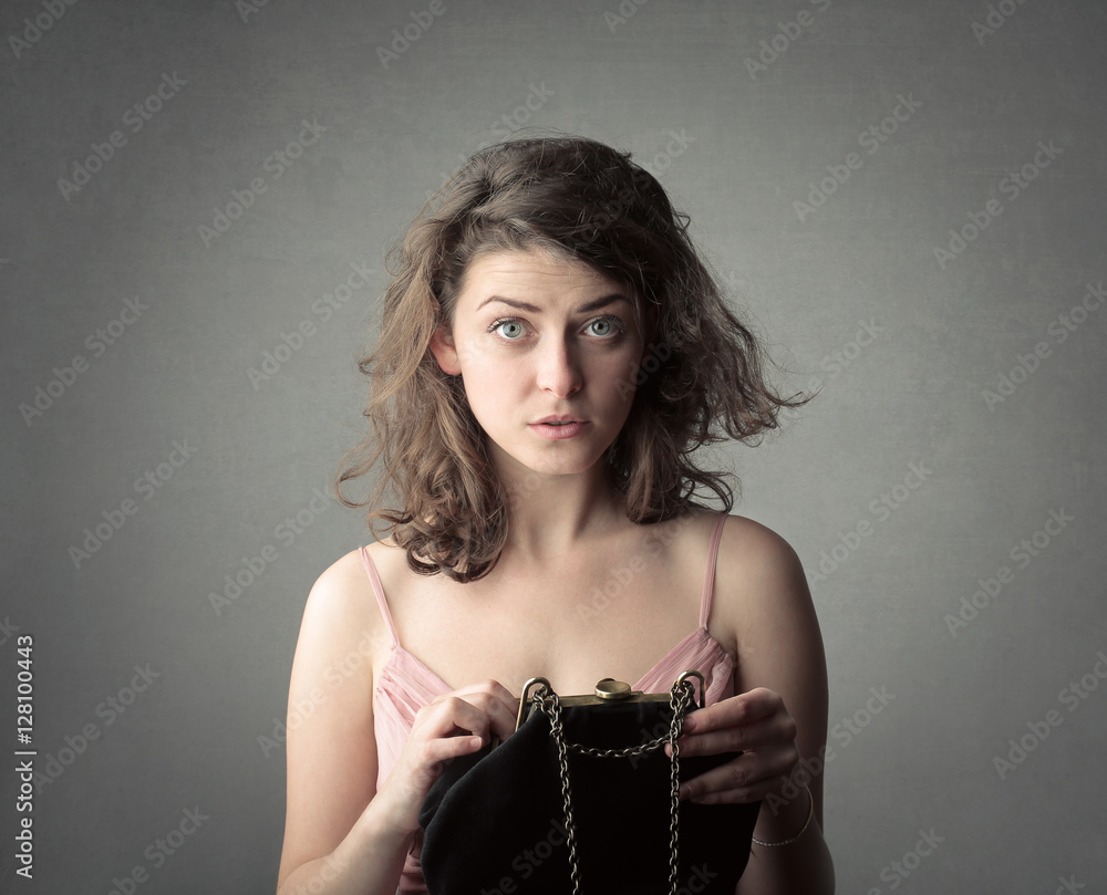 Girl holding her purse Stock Photo | Adobe Stock