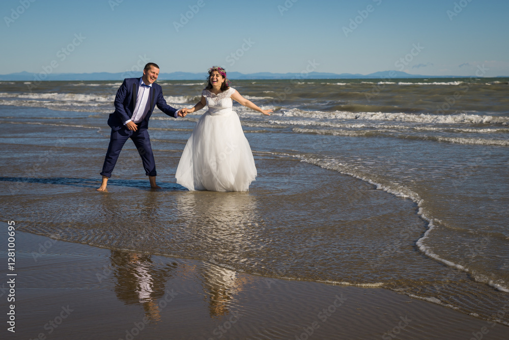Bride and groom in honeymoon in Italy, Trash the Dress, Bibione Beach, Couple in love, Romantic playful Bride and groom in honeymoon in Italy, Trash the Dress, Bibione Beach, Couple in love, Romantic playful