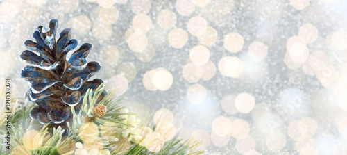 Pinecones and fir tree on sparkling background.