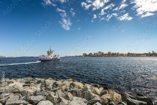 Ferry departing for Halifax from Dartmouth under deep blue sky with some clouds