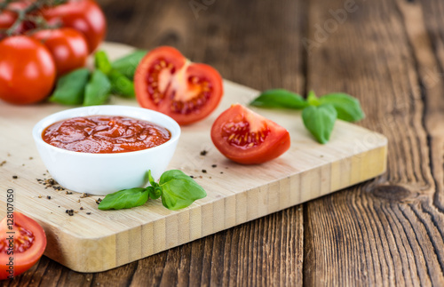 Tomato Ketchup (selective focus) on vintage wooden background