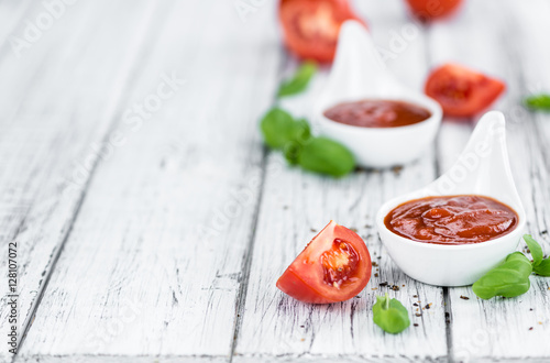 Tomato Ketchup (selective focus) on vintage wooden background