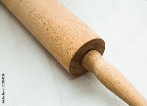 Close up of rolling pin lying on wooden table