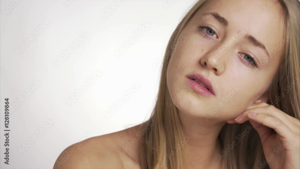 Beauty video of a young blonde pretty woman close up looking at the camera Beauty video of a young blonde pretty woman close up looking at the camera