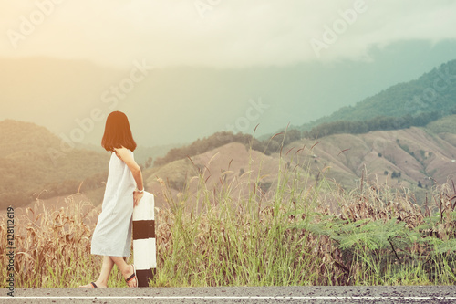 Asian woman is relax with beautiful mountain background in vintage tone
