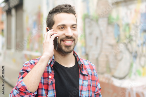 Young latin man talking on the phone. © Mego-studio