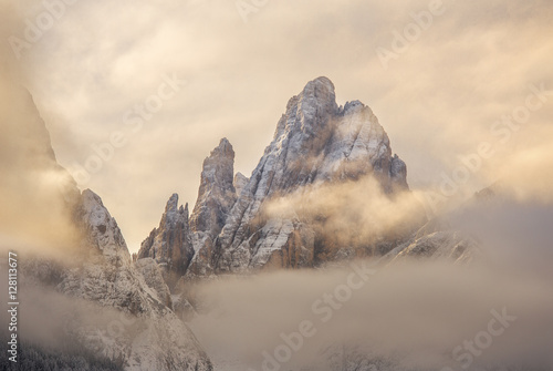 Cima Dodici mountain covered with clouds at sunrise, Bolzano, Italy 