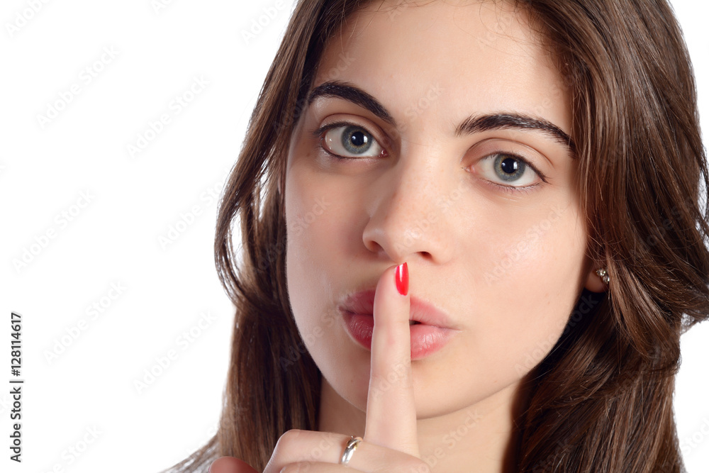 Close up of young woman making silence gesture. Close up of young woman making silence gesture.