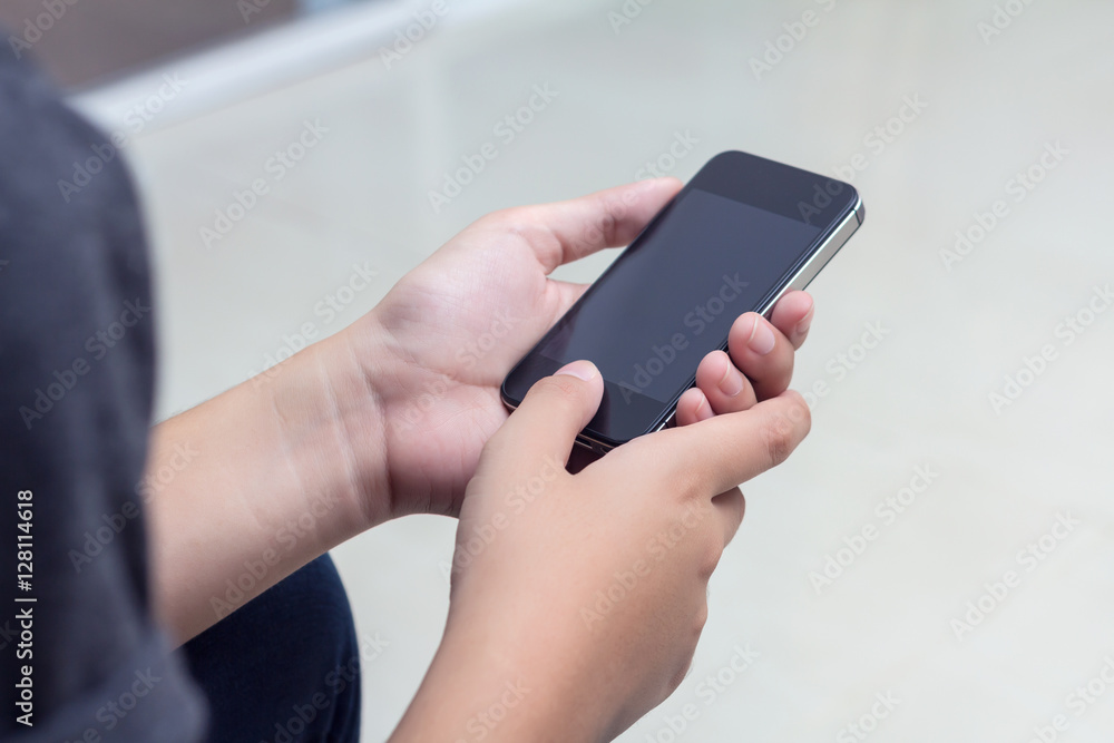 Woman with modern mobile phone in hands touching on a blank scre Woman with modern mobile phone in hands touching on a blank scre