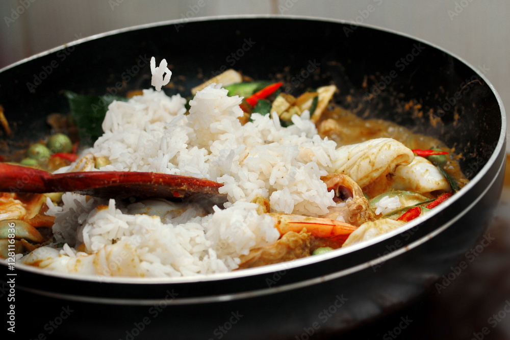 Cooking ,Fried jasmine rice in green curry with mixed meat. Cooking ,Fried jasmine rice in green curry with mixed meat.