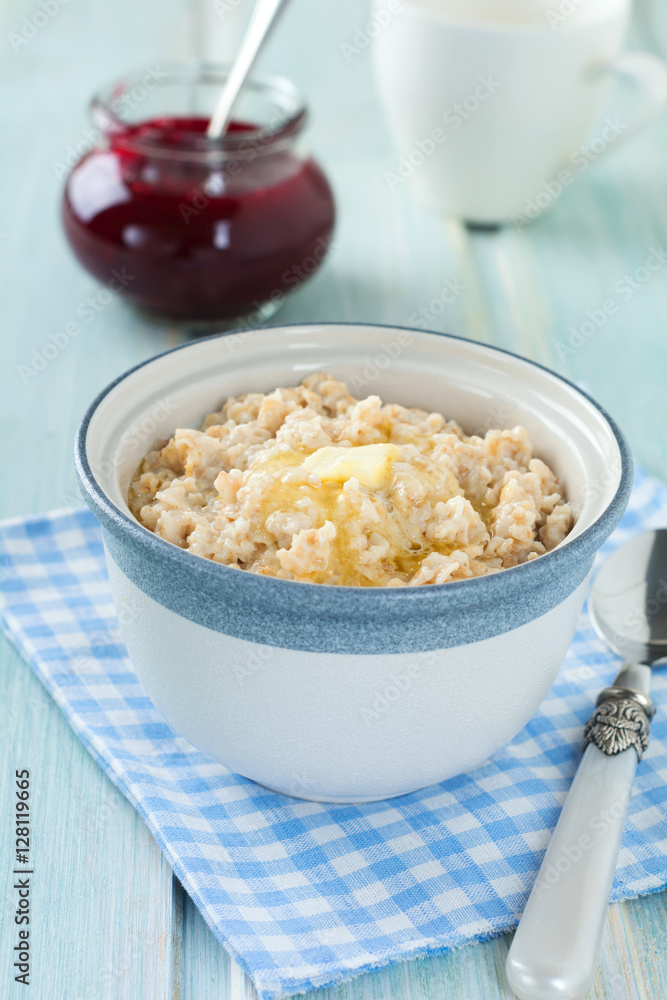 Oatmeal in a ceramic bowl for healthy breakfast on a light background. Selective focus. Oatmeal in a ceramic bowl for healthy breakfast on a light background. Selective focus.
