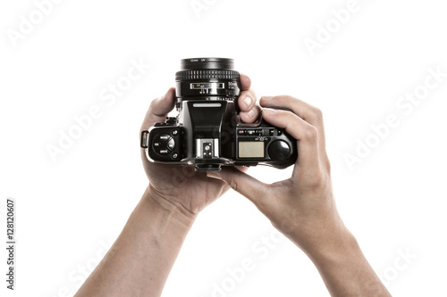 Two hands hold a vintage(old, classic) camera isolated white. 