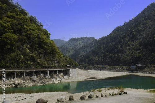 Wallpaper Mural Bridge through the mountain next to green river in China. Torontodigital.ca