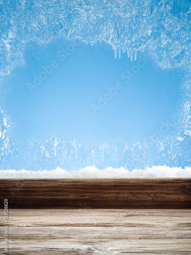 Wooden sill and frozen window. Christmas or New Year background.