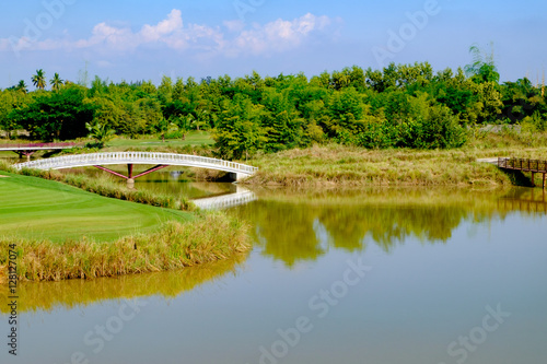 green golf field and blue cloud sky for backdrop background use
