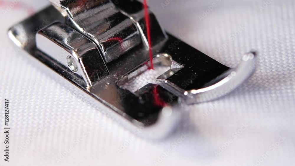 Sewing machine performs original stitch thin red thread. Slow motion Sewing machine performs original stitch thin red thread. Slow motion