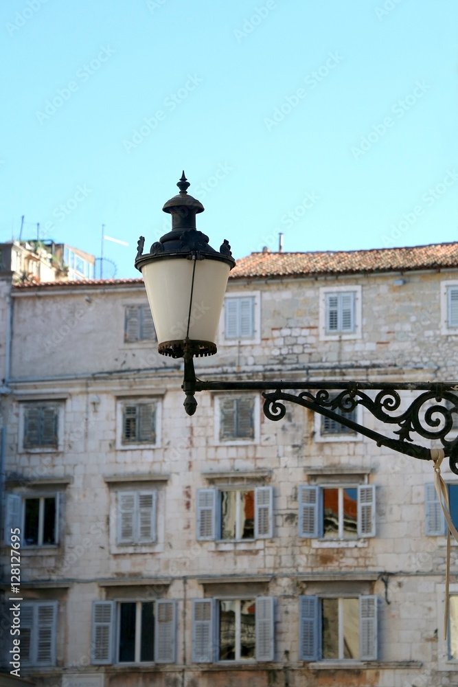 Vintage street lamp in Old Town, Split, Croatia. Traditional stone buildings in the background. Selective focus. Split is popular travel destination and UNESCO World Heritage Site.