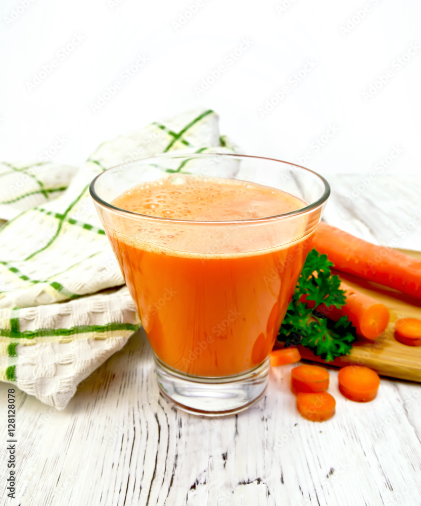 Juice carrot with vegetables and napkin on light board Juice carrot with vegetables and napkin on light board