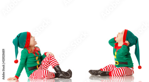 Christmas concept two children cheerful elf looking upisolated photo
