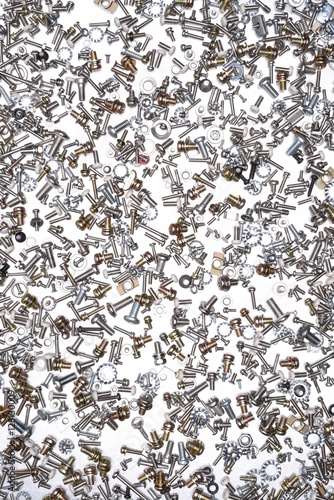 Nuts and bolts on grey metal background