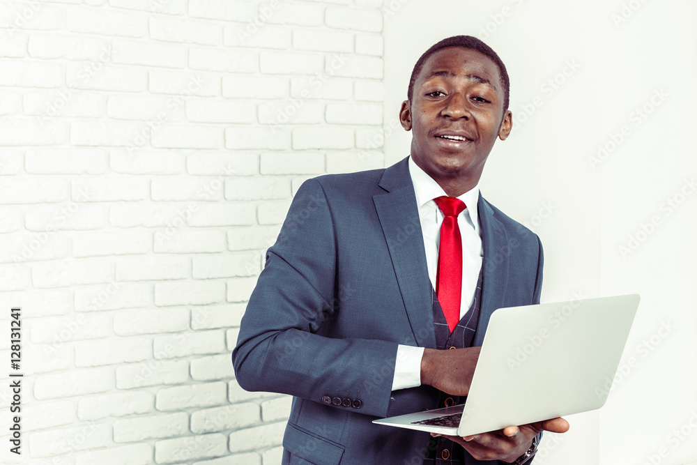African young man holding laptop African young man holding laptop