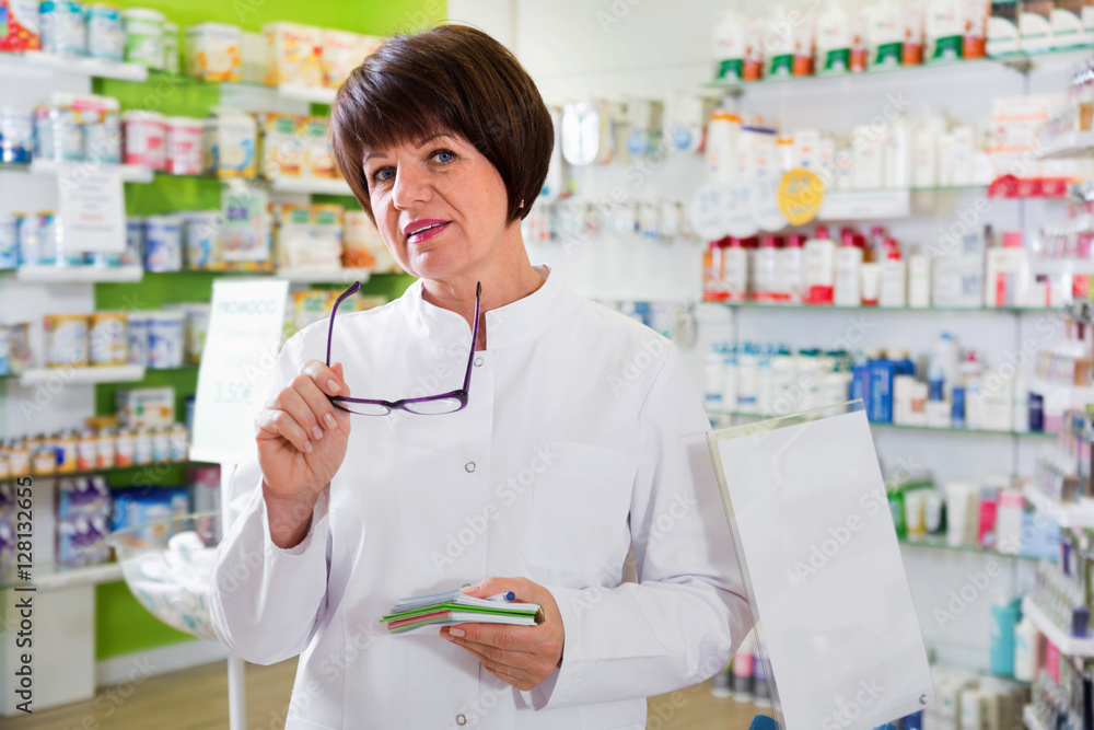 Portrait of  female druggist working in pharmacy