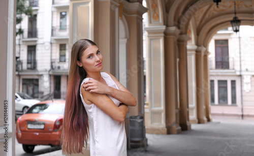 Portrait of beautiful young business woman commuter walks in the classic city, on-the-go lifestyle exterior.