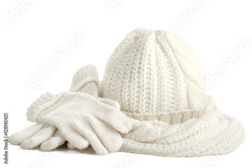  A white knitted hat, scarf and gloves isolated on white background.