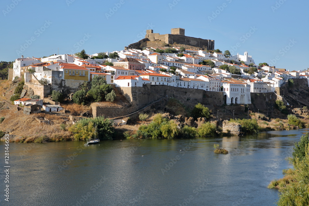 MERTOLA, PORTUGAL: General view of the fortified village from the opposite bank of the river Guadiana