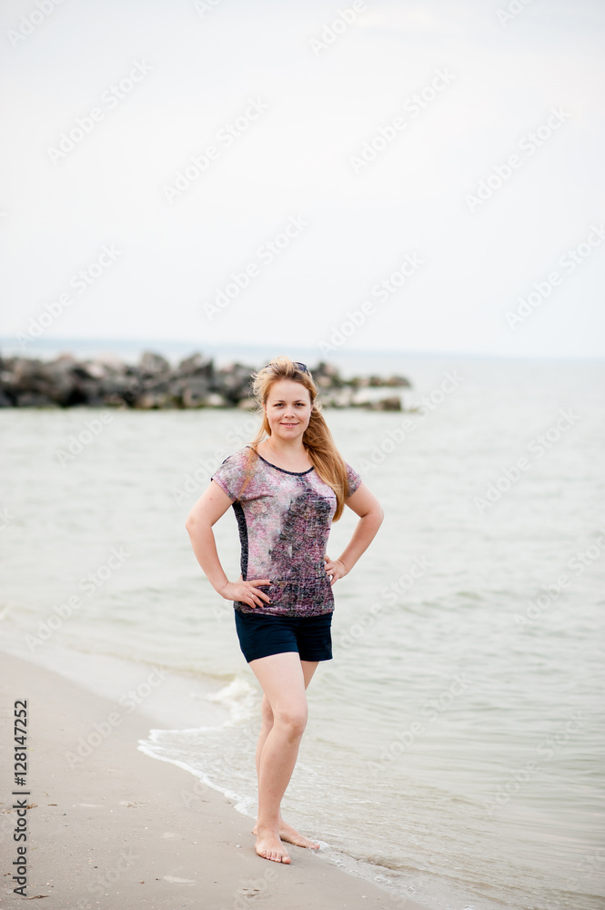 A young girl is walking in the sea A young girl is walking in the sea