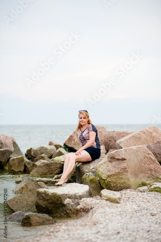 Young girl on the rocks in the sea
