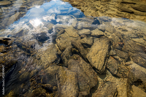 Stones in the clear water in the Altai