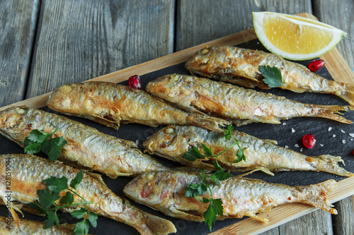 fried fish goatfish surmullet with lemon on board