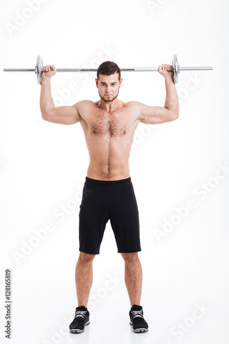 Full length athletic man with barbell