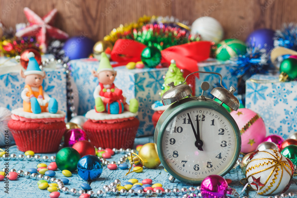 Christmas clock and cupcakes with colored decorations