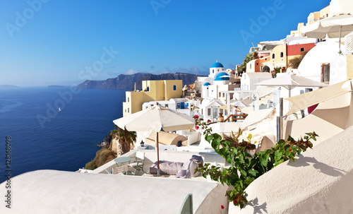 Fototapeta Naklejka Na Ścianę i Meble -  White rounded roofs in the traditional Cycladic houses in the picturesque Oia village, Santorini, Greece