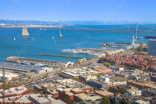 Aerial panorama of San Francisco Embarcadero and Oakland Bridge, from top of Coit Tower on sunny day. Telegraph Hill, California, United States.